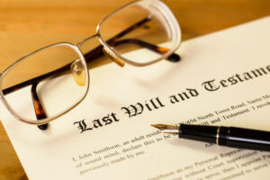 Will Lawyer Lithia, FL with a will, pen and glasses lying on a wooden table