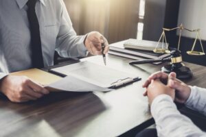 real estate attorney Florida with two people sitting across from each other reviewing documents at a desk